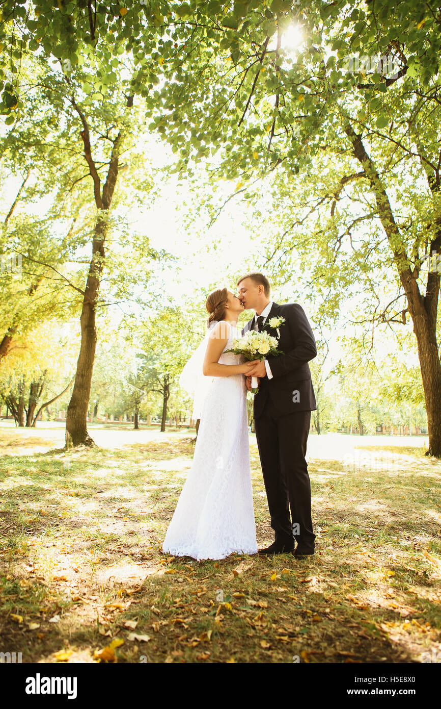 couple bride and groom on a park background Stock Photo - Alamy