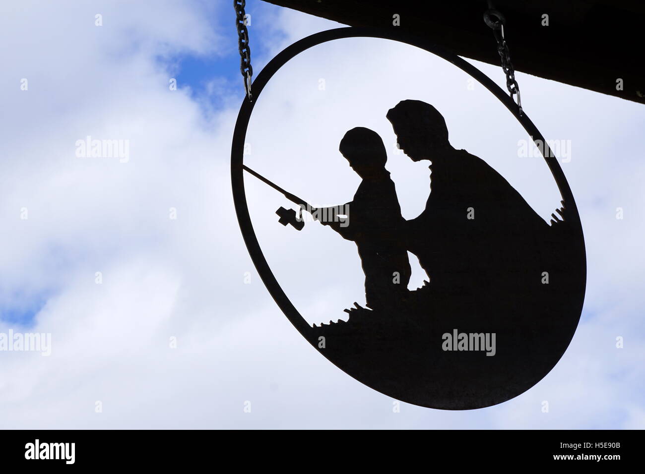 Silhouettes of father and son fishing Stock Photo