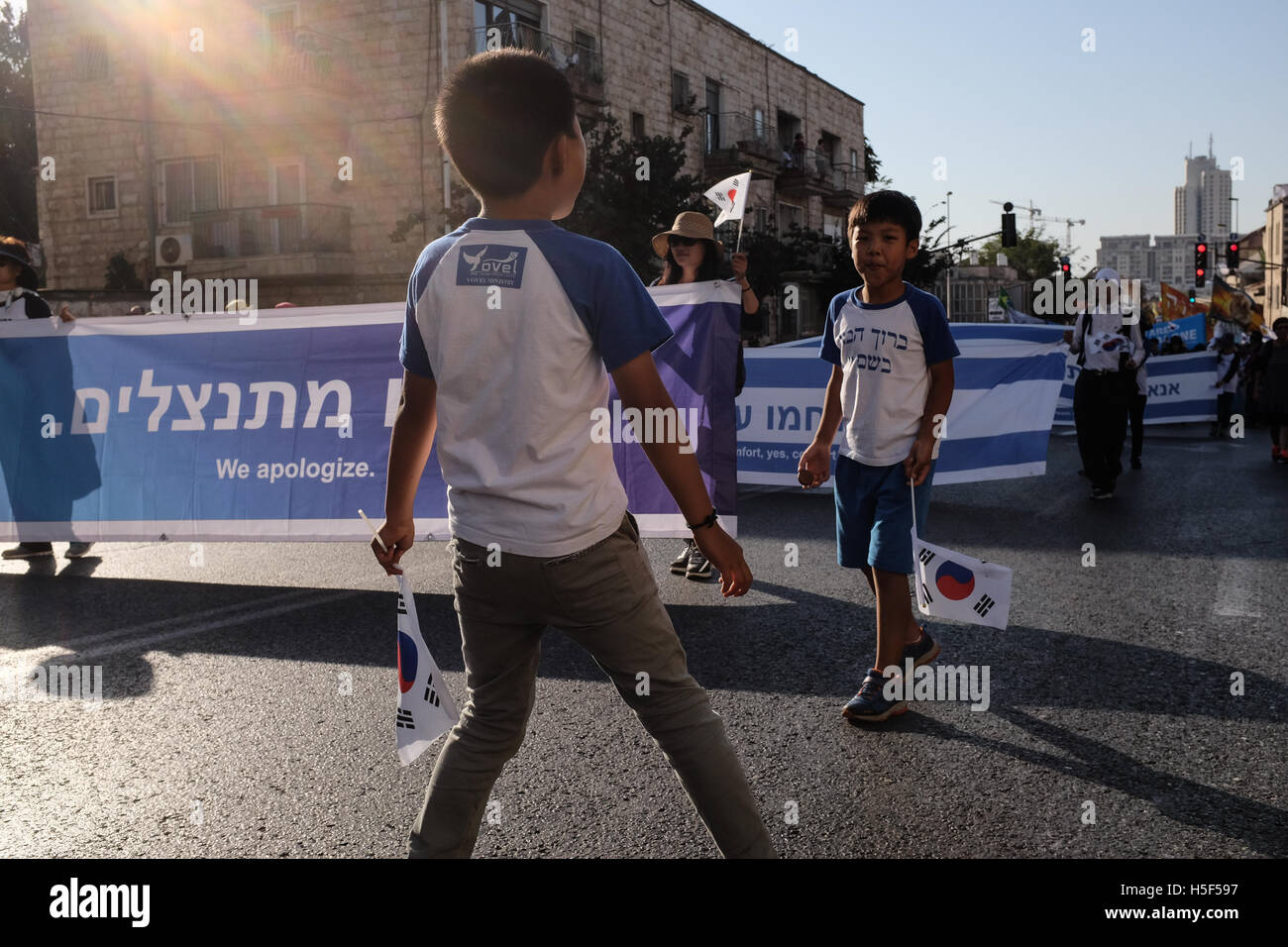 Jerusalem, Israel. 20th October, 2016. South Korean boys partake in the annual Jerusalem Parade. An estimated ten thousand people marched in the annual Jerusalem Parade including delegations from around the world, Israeli industry, banks, emergency and military personnel, in the tradition of Temple Mount pilgrimages on the holiday of Sukkoth and in a show of international support for Israel. Credit:  Nir Alon/Alamy Live News Stock Photo