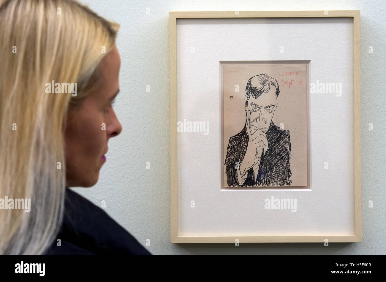 A woman looking at a self portrait of Lyonel Feininger from 1908 at the Art Museum Moritzburg in Halle/Saale, Germany, 20 October 2016. The drawing is part of an exhibition on a painting that was assumed lost. With the motto 'Lyonel Feininger. Paris 1912. The return of a lost painting', the exhibition follows the reasons of Feininger to cut, wash and not finish his work 'An der Seine, Paris' (1912). The exhibition is open from 24 October at Moritzburg. PHOTO: HENDRIK SCHMIDT/dpa Stock Photo