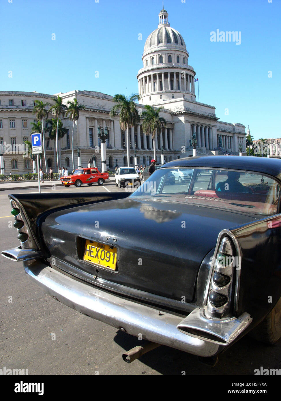 Feb 15, 2006; Havana, CUBA; One of many Cuban Maquinas, aka Yank tanks or pre 1960 American Classic cars in the streets of Havana  with Capitolio Nacional (National Capitol building). One in eight cars in Cuba today is a pre-1960s American brand Ford, Chevrolet, Cadillac, Chrysler, Packard and other classic models. The Republic of Cuba is located in the northern Caribbean and south of the United States. The first European to visit Cuba was explorer Christopher Columbus in 1492. Centuries of colonial rule and revolutions followed. Batista was deposed by Fidel Castro and Che guevara in 1953. Aft Stock Photo
