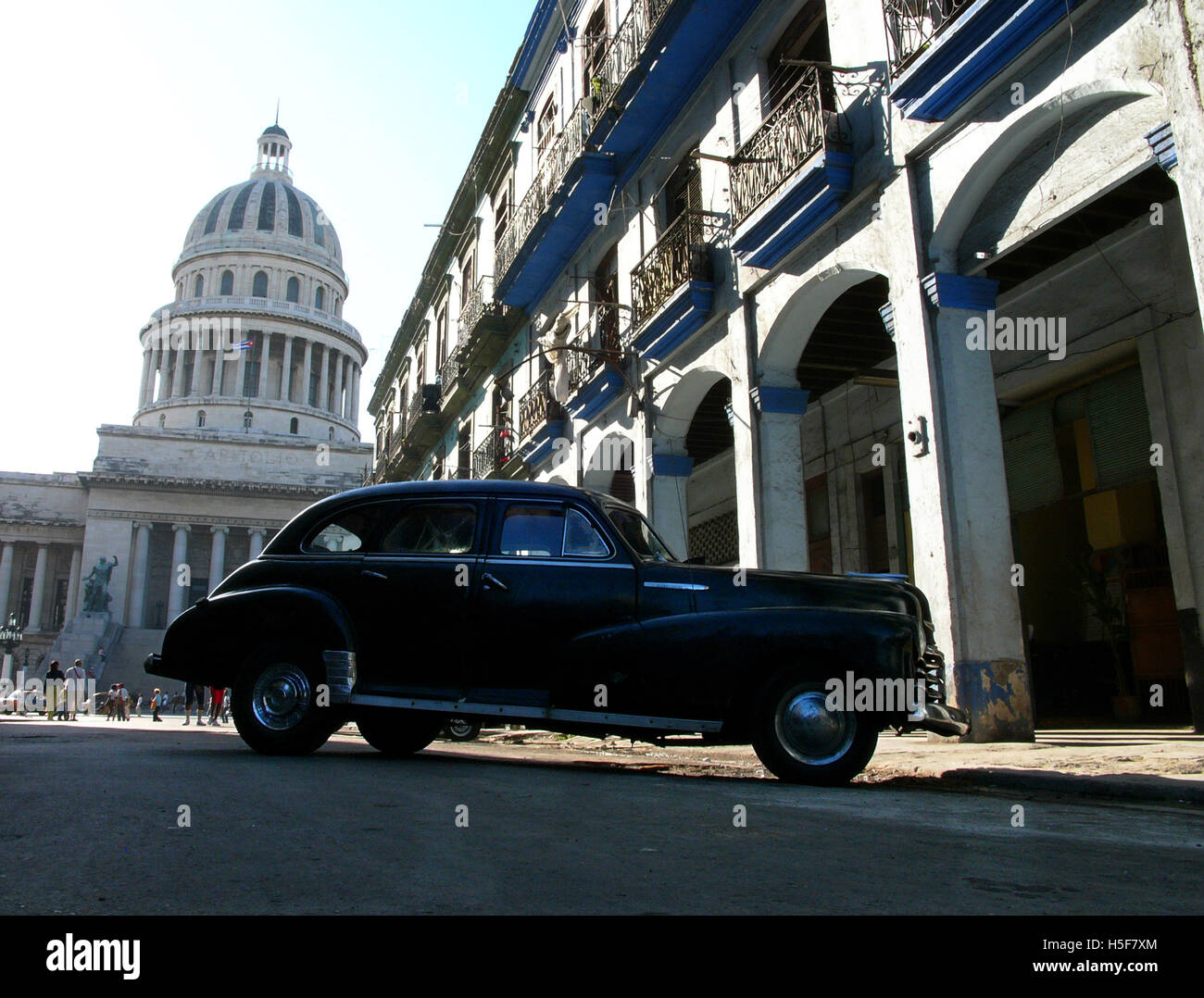 Feb 15, 2006; Havana, CUBA; One of many Cuban Maquinas, aka Yank tanks or pre 1960 American Classic cars in the streets of Havana with Capitolio Nacional (National Capitol building). One in eight cars in Cuba today is a pre-1960s American brand Ford, Chevrolet, Cadillac, Chrysler, Packard and other classic models. The Republic of Cuba is located in the northern Caribbean and south of the United States. The first European to visit Cuba was explorer Christopher Columbus in 1492. Centuries of colonial rule and revolutions followed. Batista was deposed by Fidel Castro and Che guevara in 1953. Afte Stock Photo