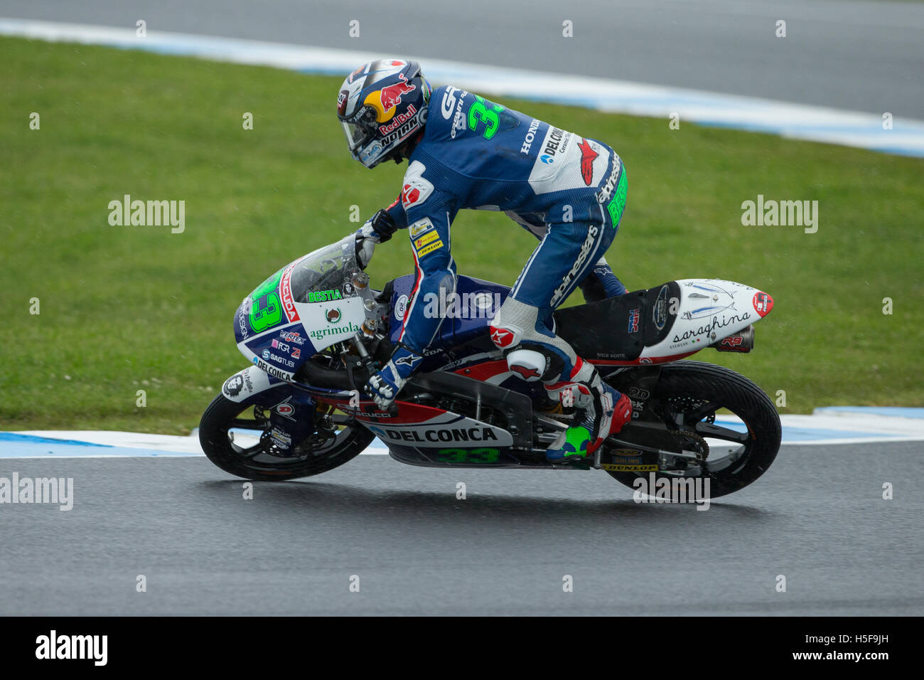 Enea Bastianini crashes during a wet Friday free practice at Phillip Island in the Moto3 category. Stock Photo