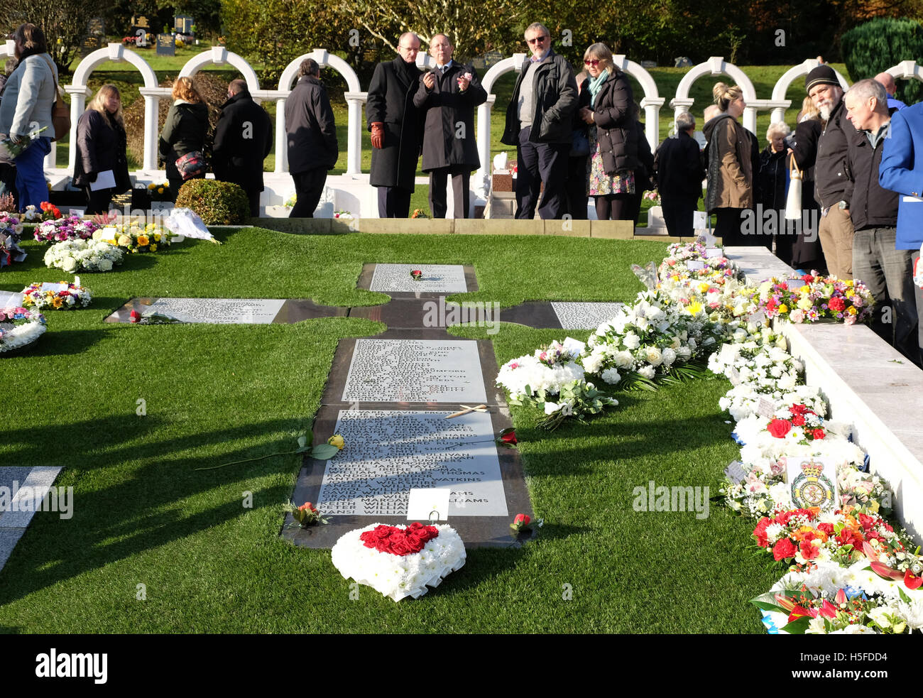 Aberfan, Wales - Friday 21st October 2016 - Relatives and villagers attend the cemetery in Aberfan to mark the 50th Anniversary of the terrible tragedy that took place on 21st October 1966. 144 people including 116 young children were killed when a mountain of coal waste slid down into the village and school. Credit:  Steven May/Alamy Live News Stock Photo