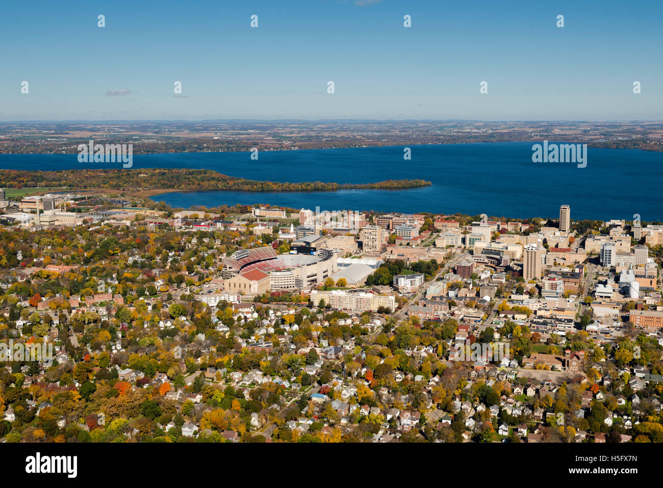 An aerial view of Madison, Wisconsin,  the University of Wisconsin-Madison's Camp Randall Stadium, surrounded by Lakes Mendota ( Stock Photo
