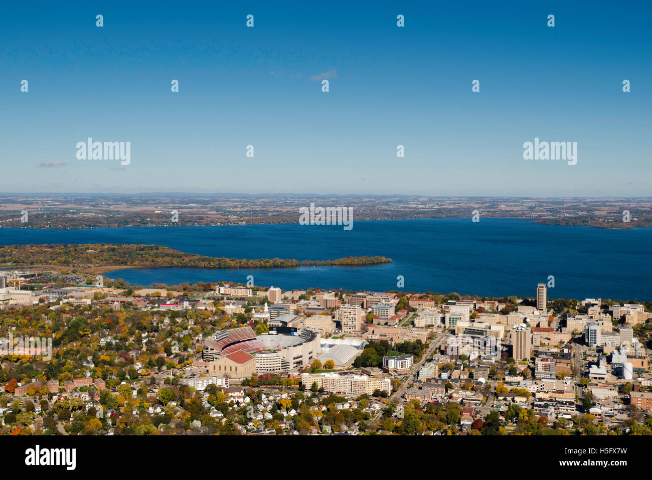 An aerial view of Madison, Wisconsin,  the University of Wisconsin-Madison's Camp Randall Stadium, surrounded by Lakes Mendota ( Stock Photo