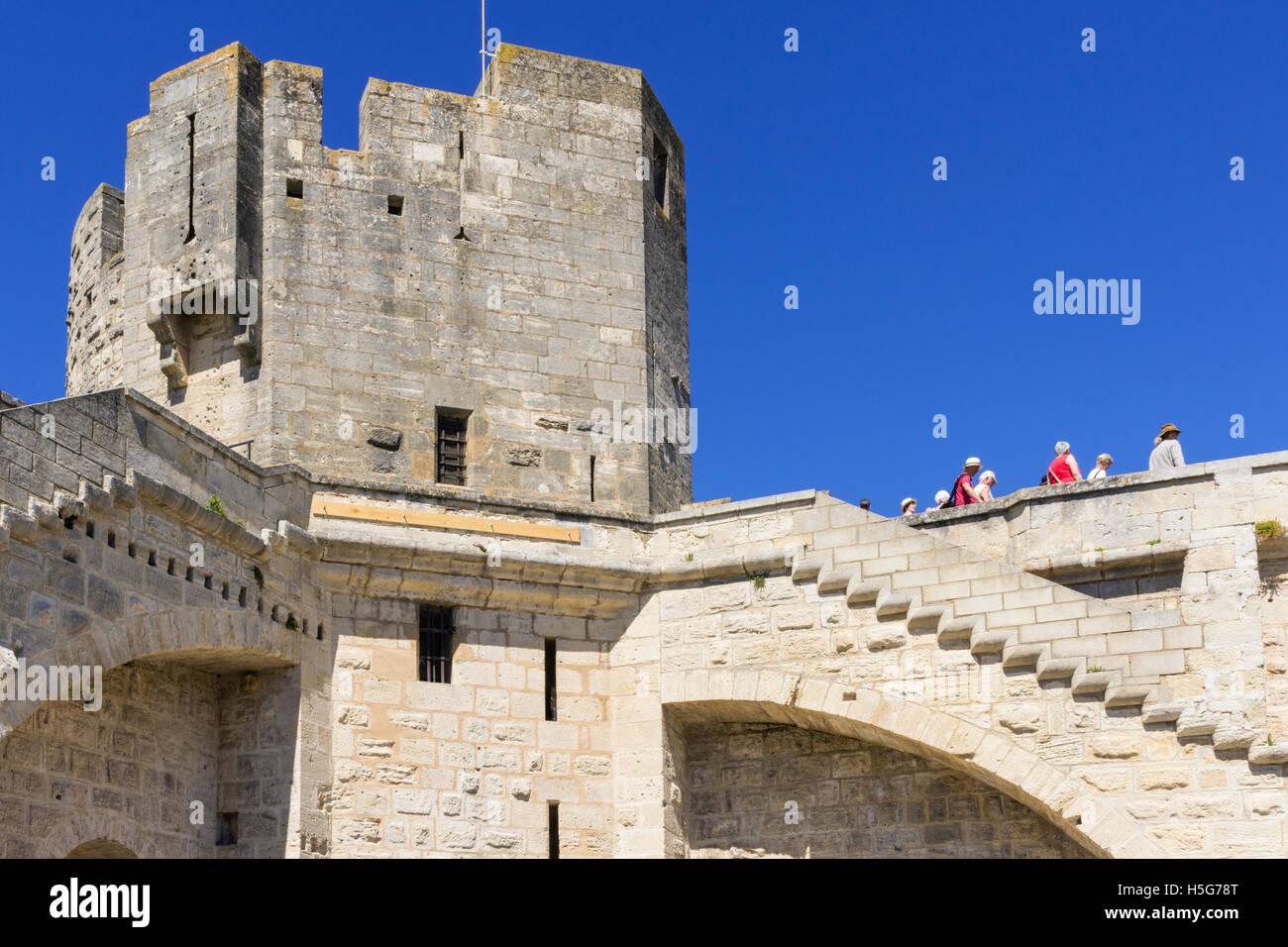 Tourists walking the medieval walls of Aigues-Mortes, France Stock Photo