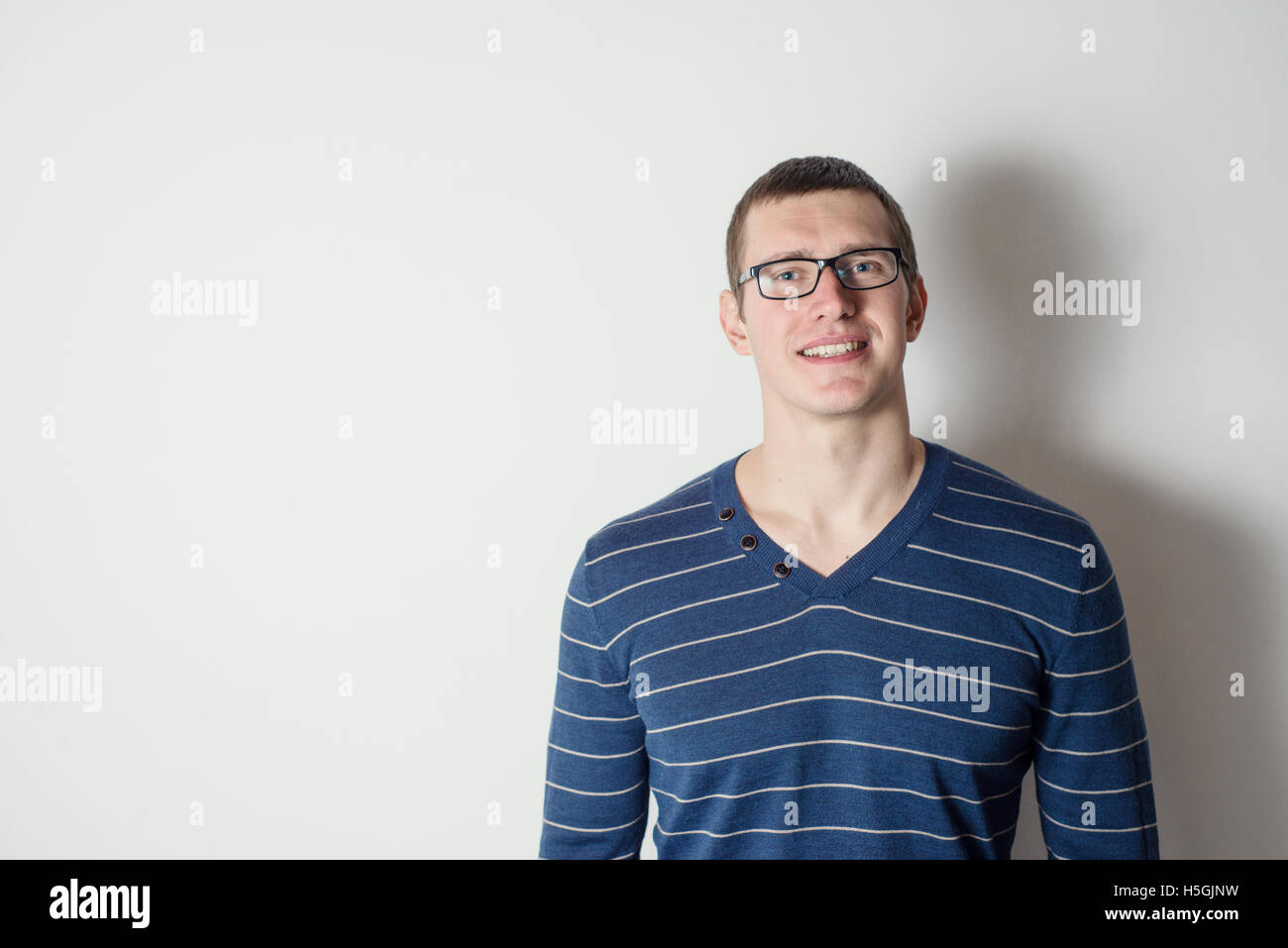 Portrait of a cheerful young man wearing glasses Stock Photo - Alamy