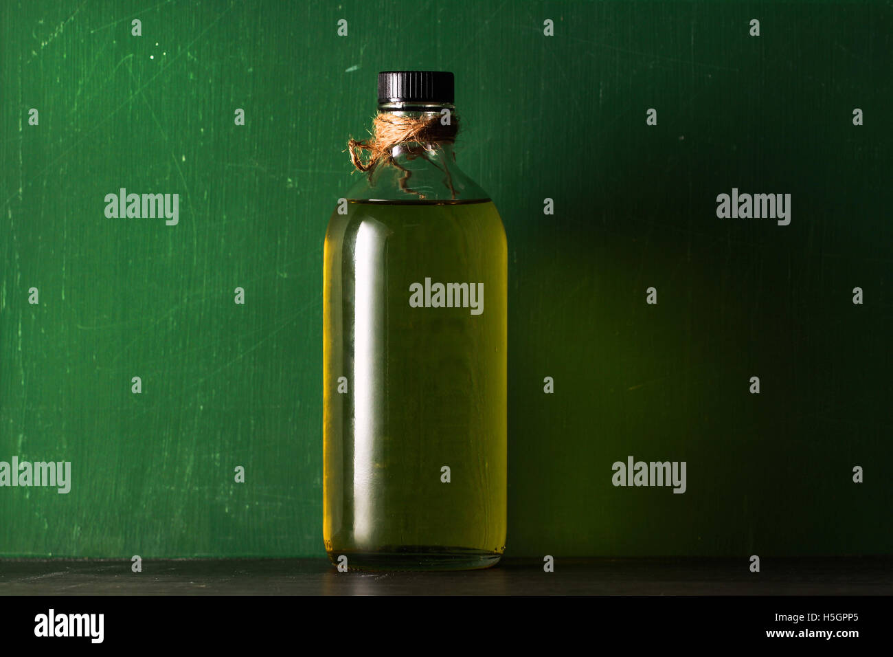 olive oil in the bottle on green background Stock Photo - Alamy
