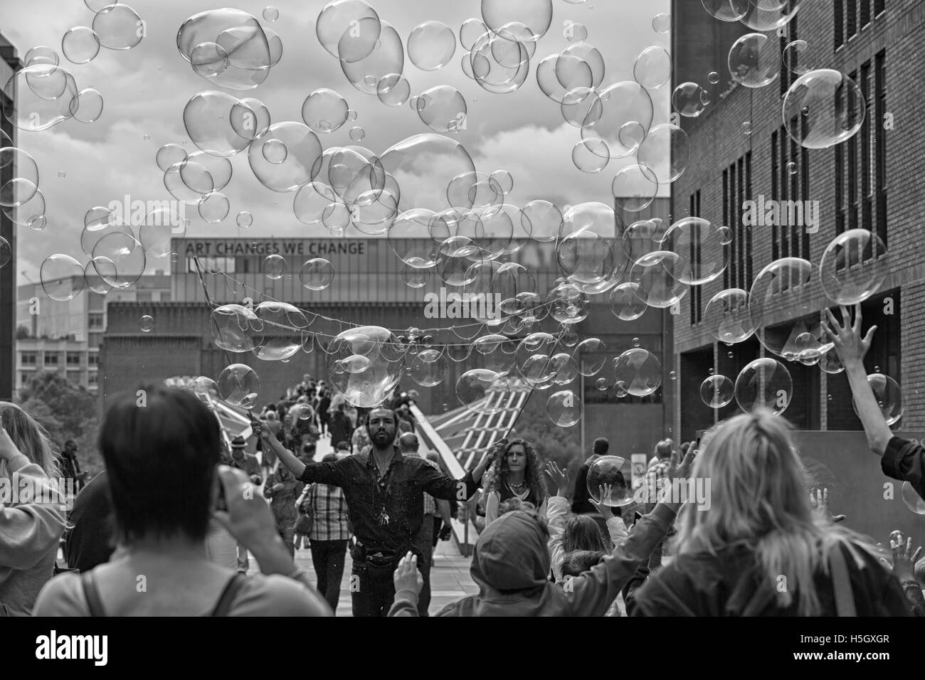 London, UK - July 2016:  Bubbles from a street entertainer, with St Paul's Cathedral in the background, on the South Bank London Stock Photo