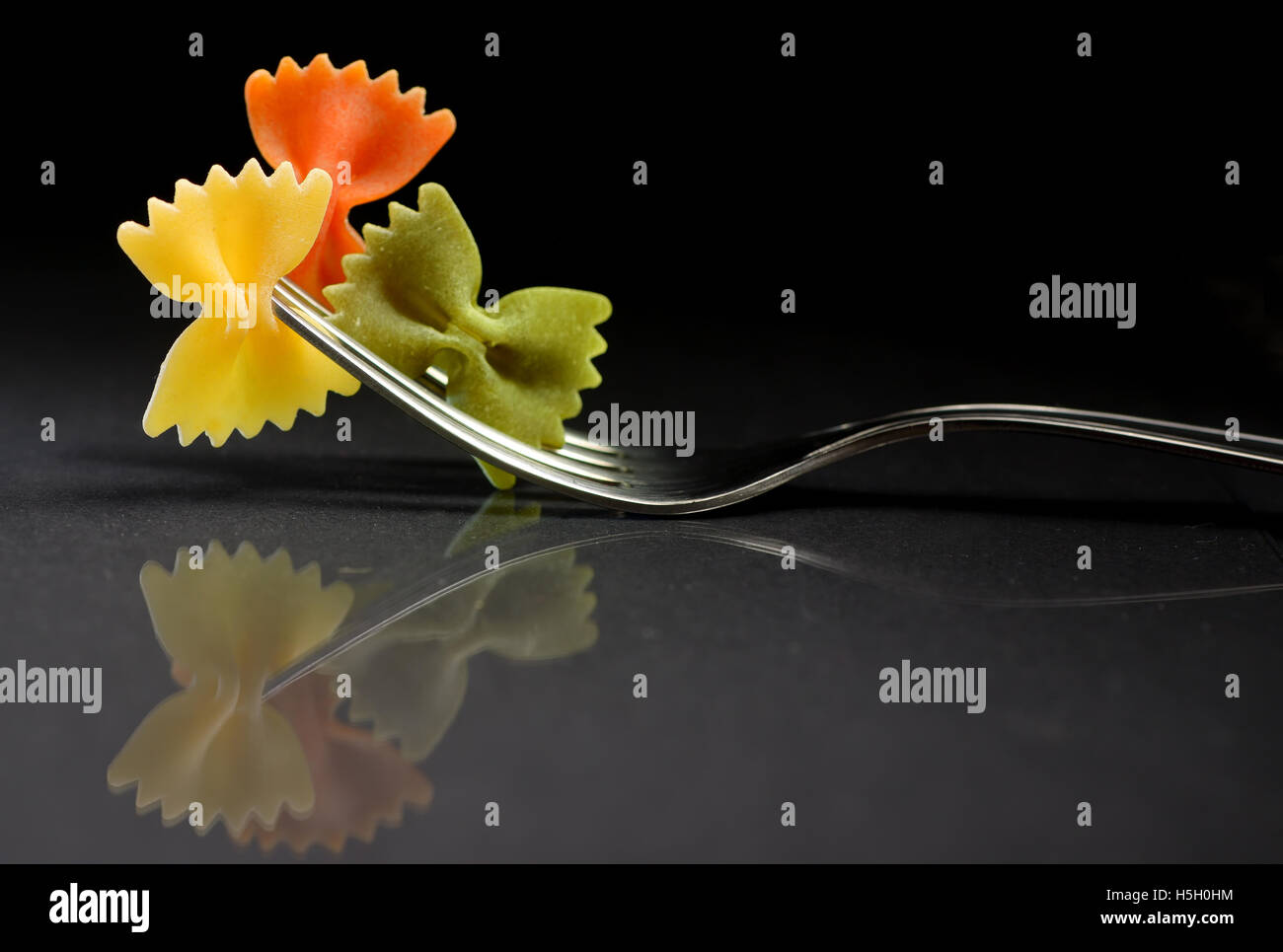 Reflexion of pasta farfalle on a fork Stock Photo