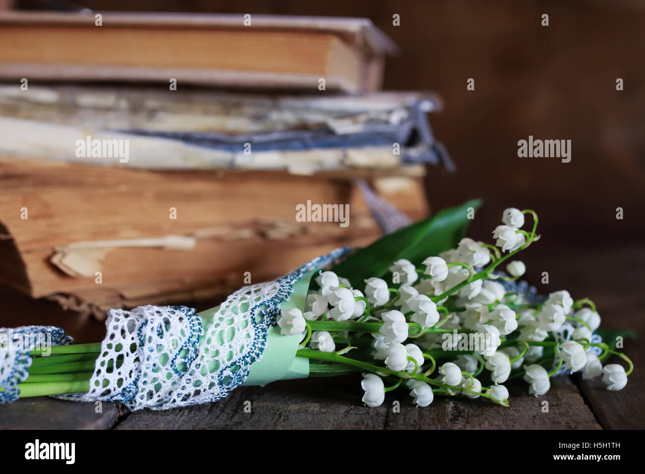 bouquet of fresh lilies of the valley and retro book Stock Photo Alamy