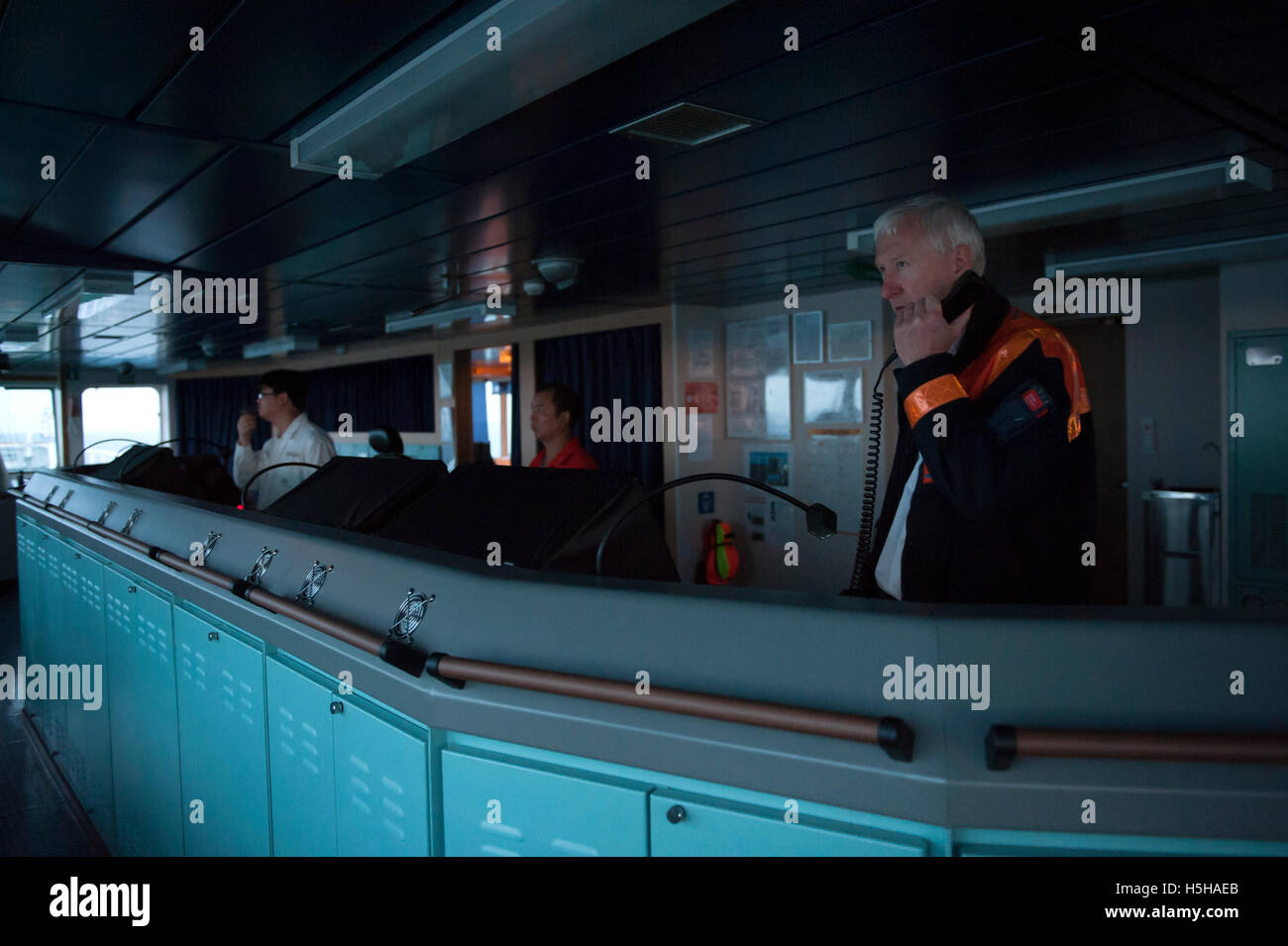 Pilot on the bridge of a container ship Stock Photo