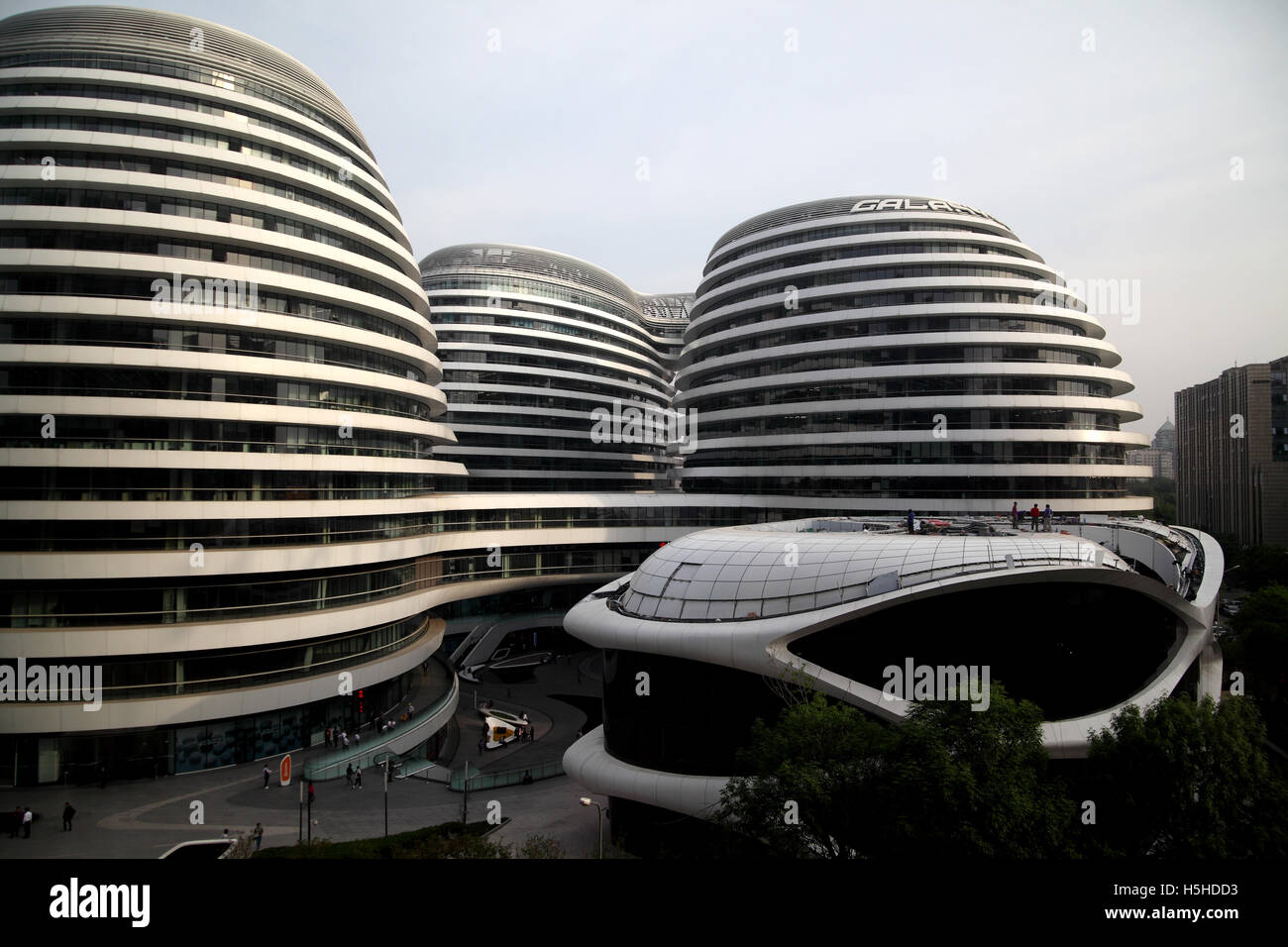 The Galaxy Soho complex of buildings designed by architect Zaha Hadid with repairs being done on the roof of one of the parts. Stock Photo