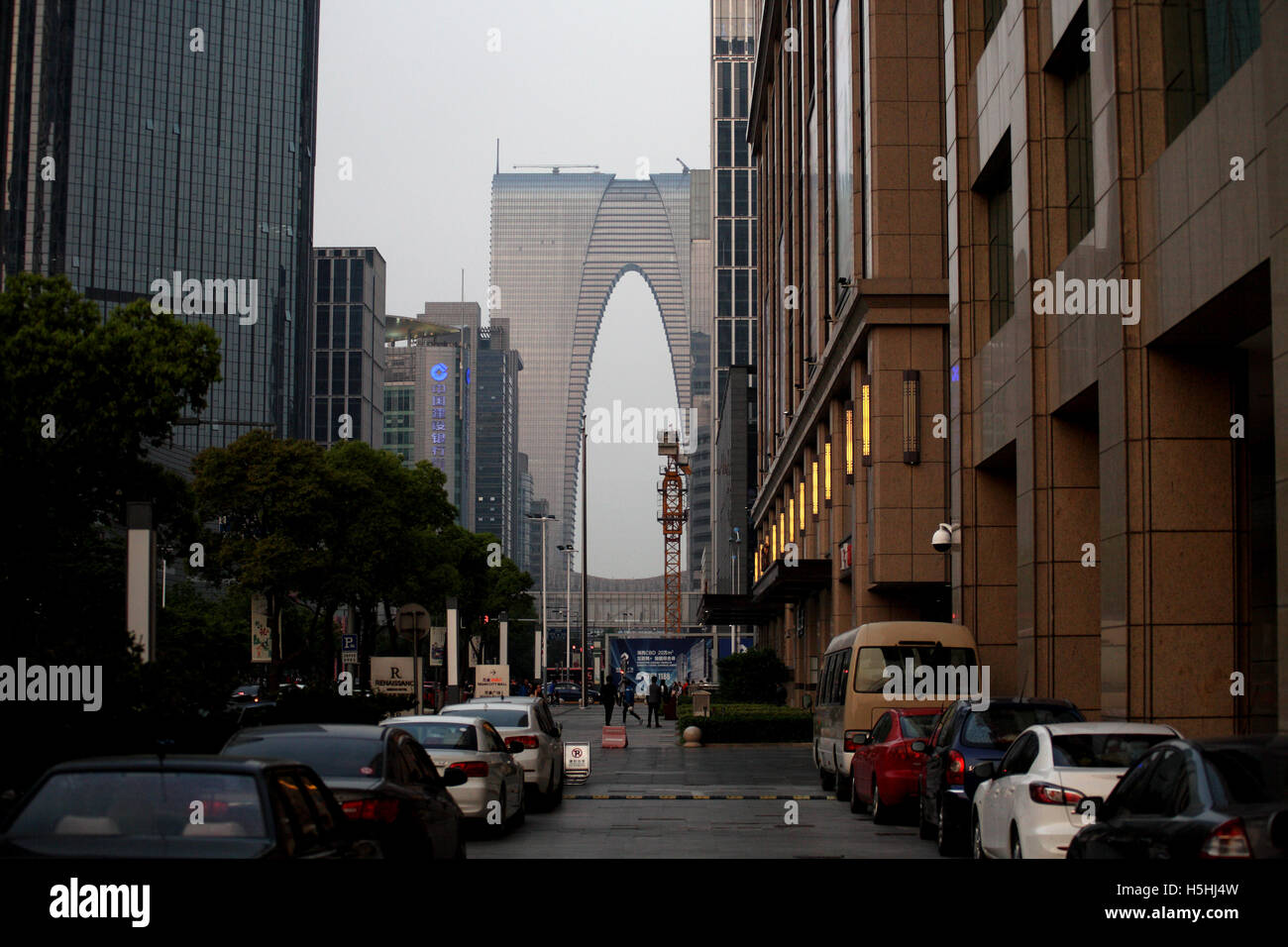 The architecturally exciting Oriental Gate seen at dusk with other high rise buildings around. Suzhou, China. 28.04.2016. Stock Photo