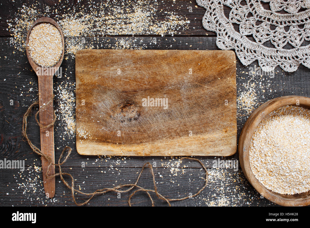 Oat bran in the wooden bowl on the dark table Stock Photo