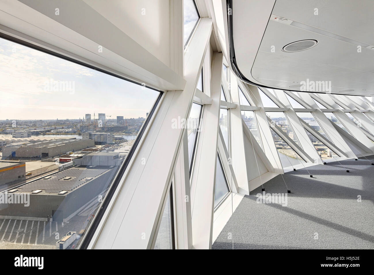 Corridor with triangular window panes. Port House, Antwerp, Belgium. Architect: Zaha Hadid Architects, 2016. Stock Photo