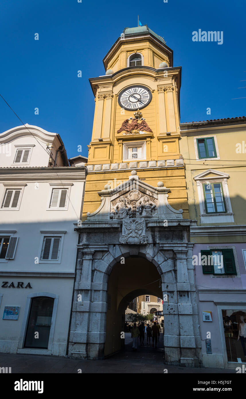 Baroque city clock tower above the arched gateway linking the Korzo to the inner city, designed by Filbert Bazarig in 1876, Rije Stock Photo