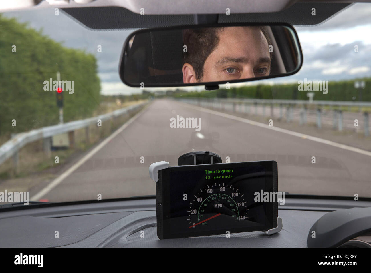 Chris Burbridge, Autonomous Driving Software Engineer for Tata Motors European Technical Centre, demonstrates the car manufacturer's GLOSA V2X functionality, which is connected to the traffic lights and shares information with the driver, during the first demonstrations of the UK Autodrive Project at HORIBA MIRA Proving Ground in Nuneaton, Warwickshire. Stock Photo