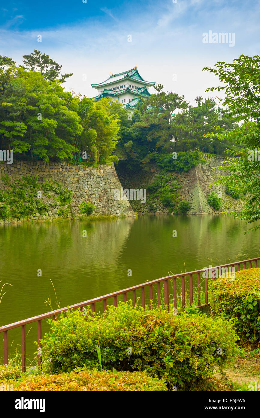 Historic Nagoya Castle stronghold above its rampart walls across the water moat in center Nagoya, Japan Stock Photo
