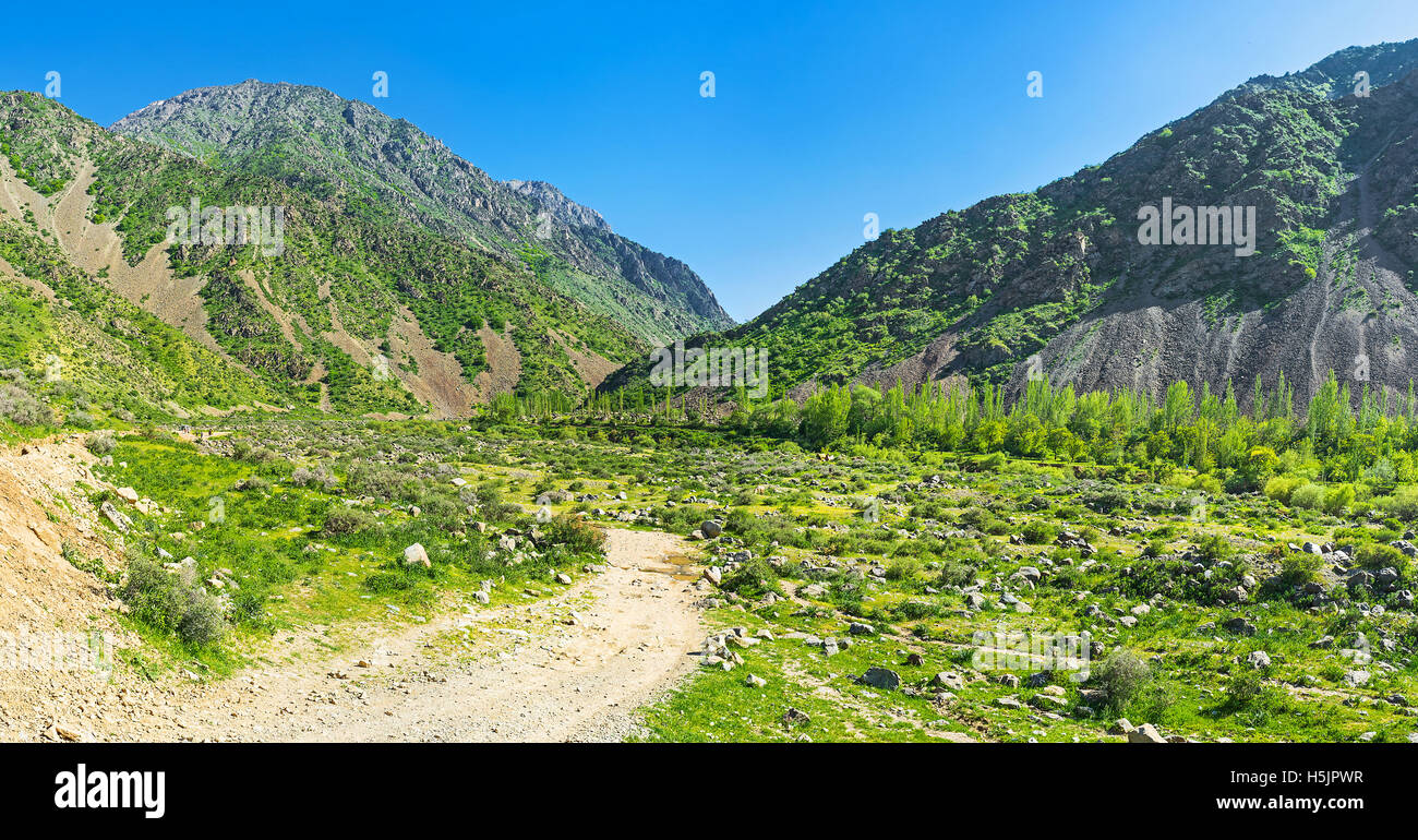 The dusty path leads to the winding Zarmas gorge in Gissar Range of Pamir-Alay mountains, the territory of Gissar Nature Reserve Stock Photo