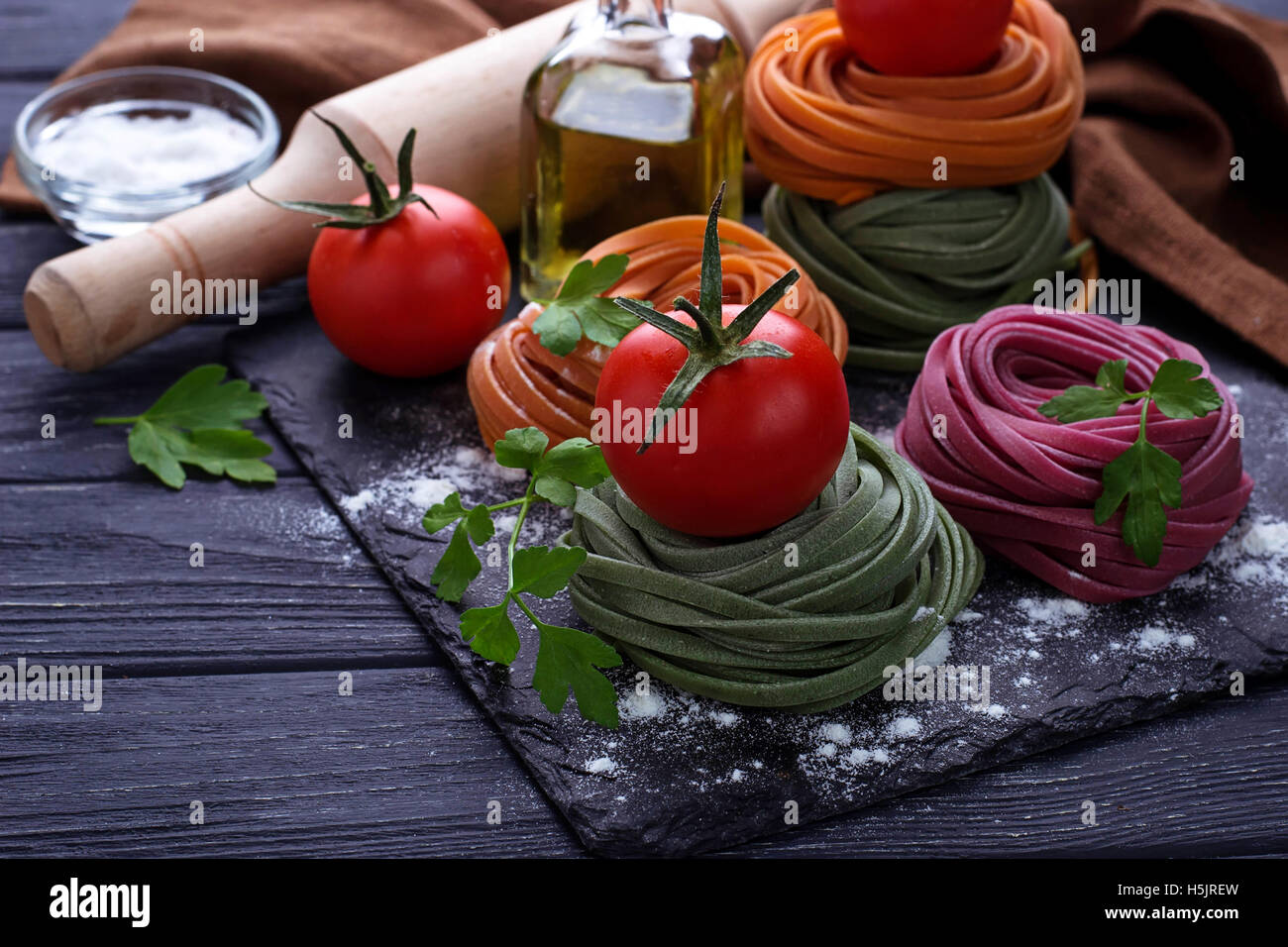 Uncooked color pasta tagliatelle. Selective focus Stock Photo - Alamy