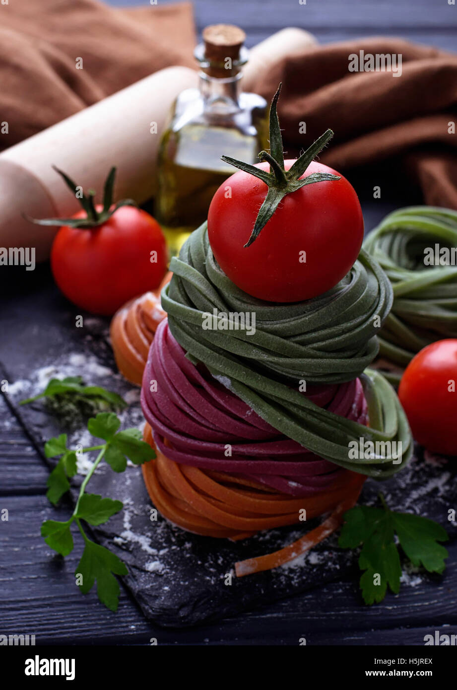 Uncooked color pasta tagliatelle. Selective focus Stock Photo - Alamy