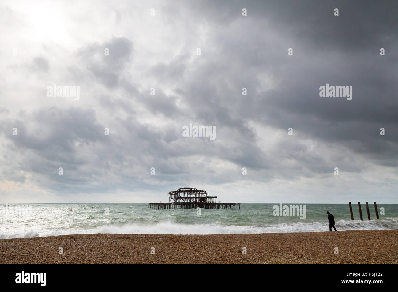 Stormy sky over the burned out remains of the West Pier, Brighton, East Sussex, England UK Stock Photo