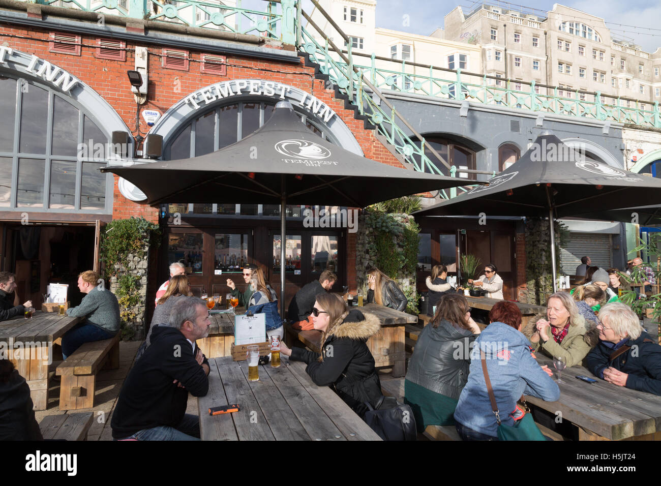 People sitting outside drinking at the Tempest Inn, Brighton promenade, Brighton, East Sussex England UK Stock Photo