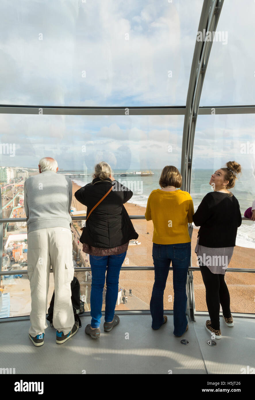 People looking out over Brighton from inside the i360 observation tower, Brighton, Sussex UK Stock Photo