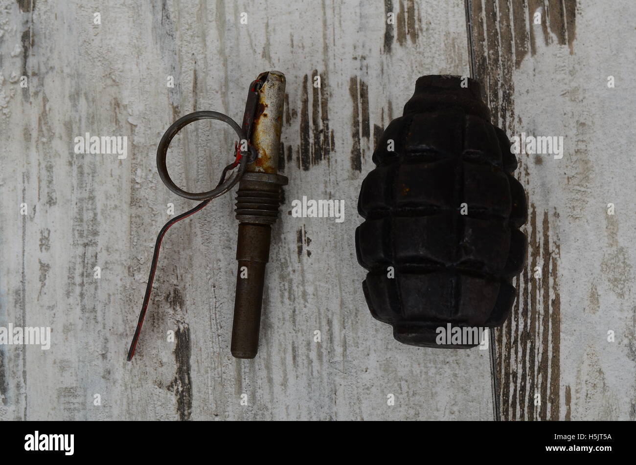 Old Hand Grenade on wood background. disguise, alarm Stock Photo