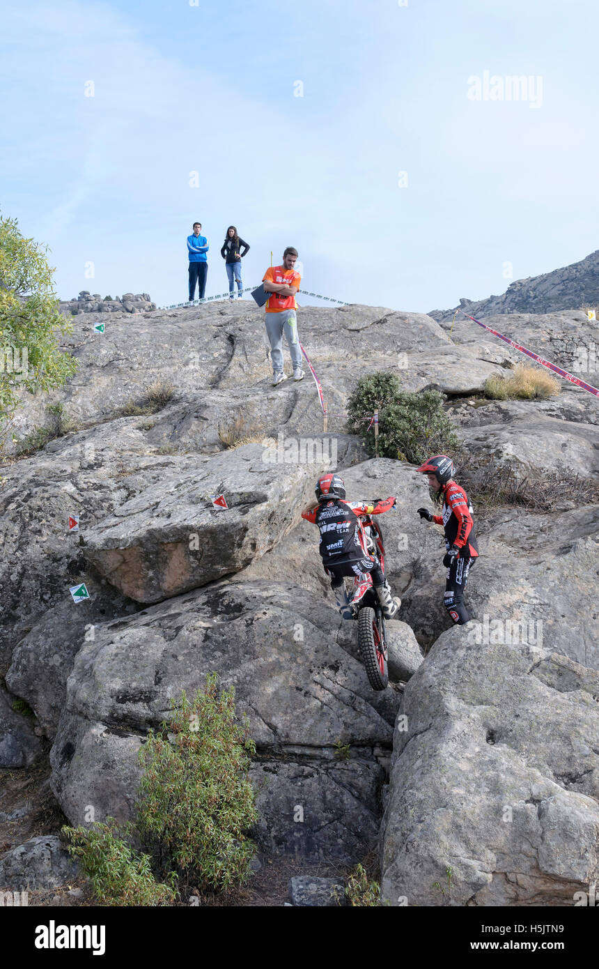 Motorcycling. Trial race. Spain championship. Carla Caballe overtaking an obstacle, over granite stones, in Valdemanco Stock Photo
