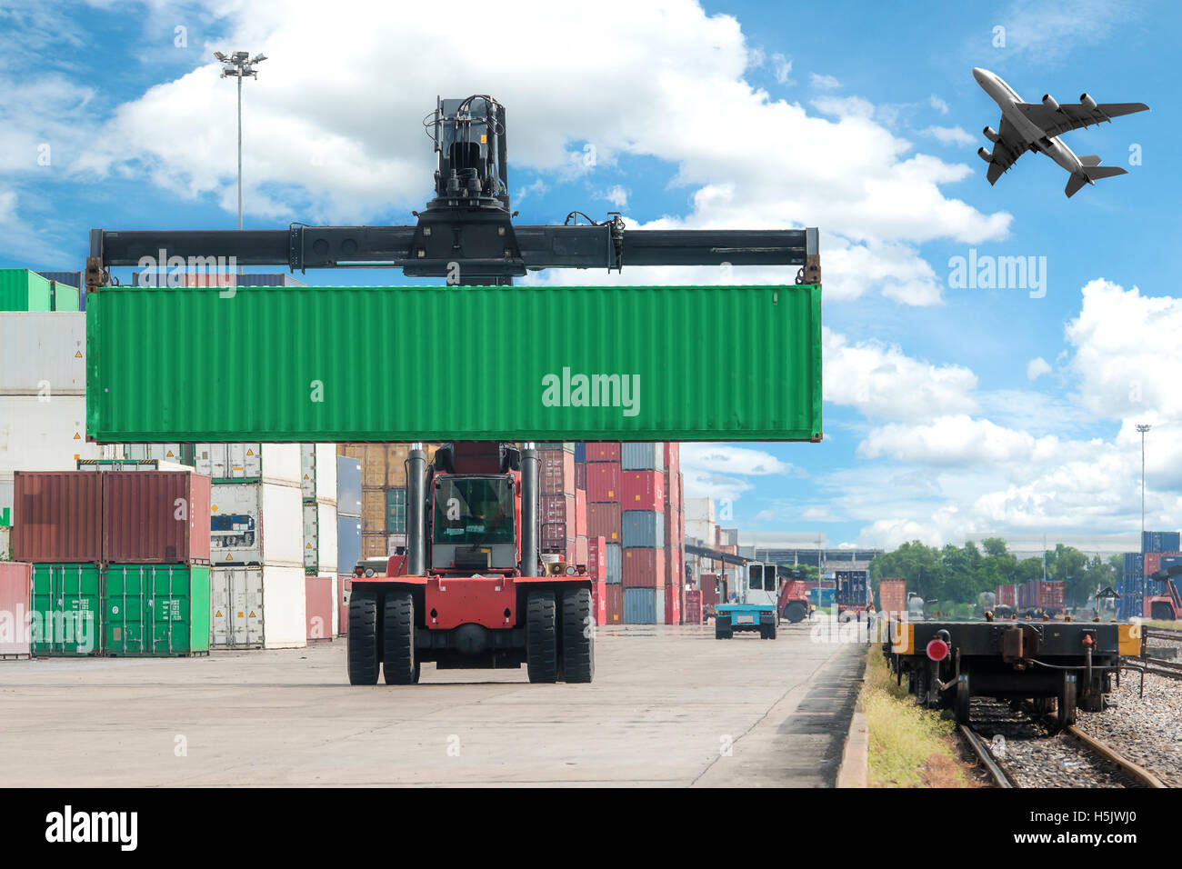 forklift handling container box loading to freight train Stock Photo
