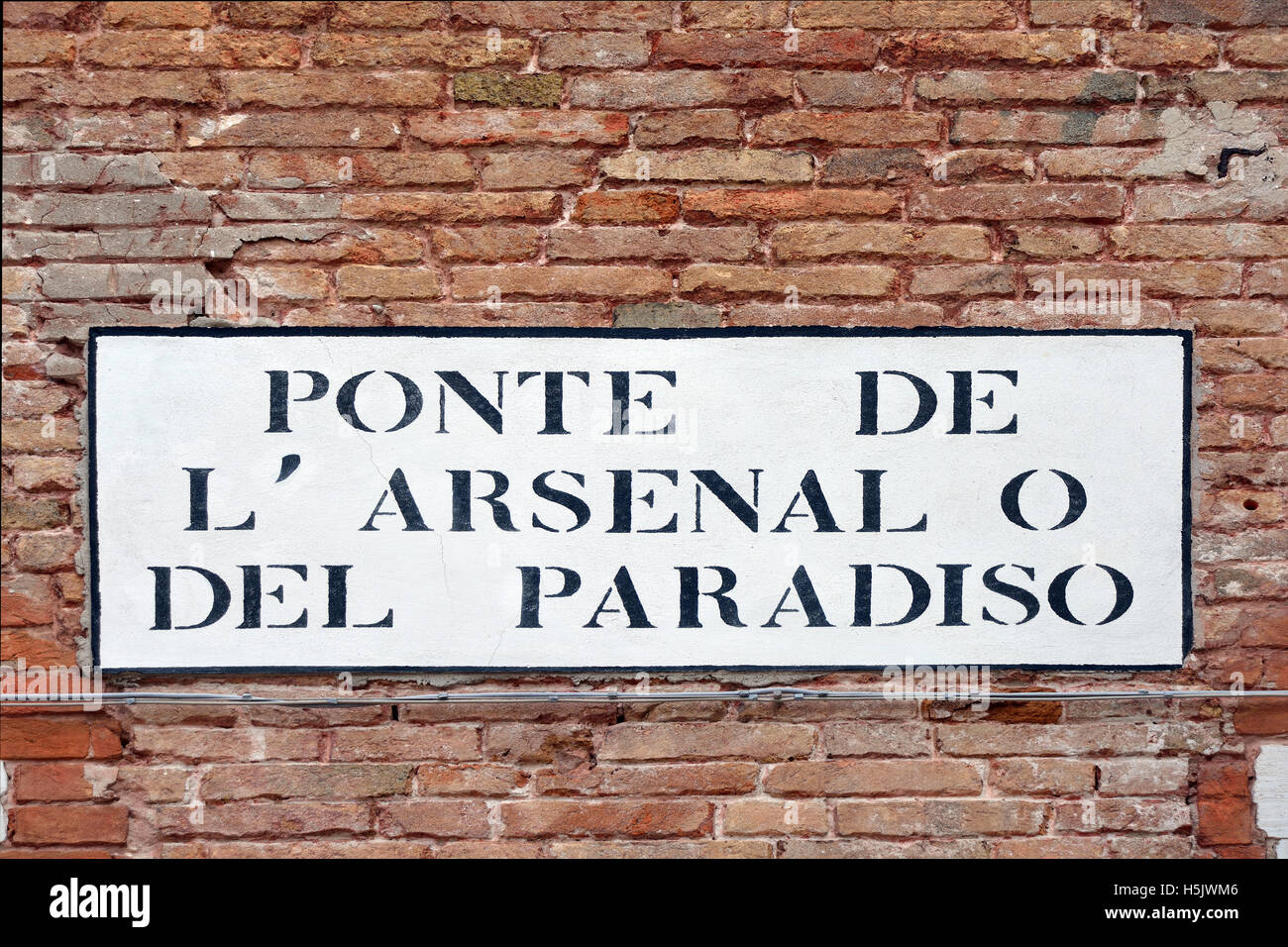 Street sign from the historic Venetian Arsenal in Castello district of Venice in Italy - Ponte de l’Arsenale del Paradiso. Stock Photo