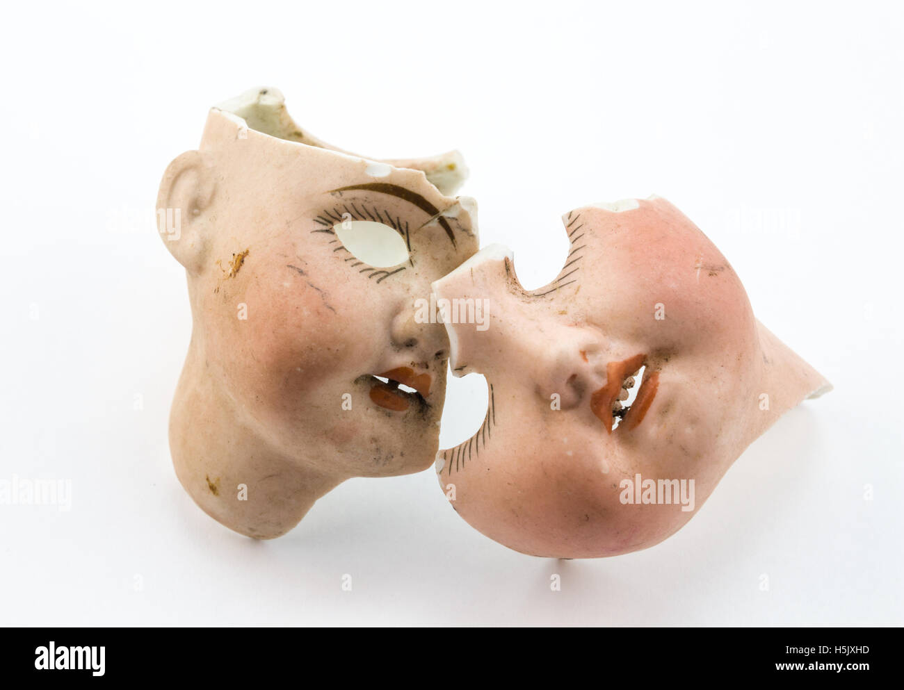 Broken doll parts on white background Stock Photo
