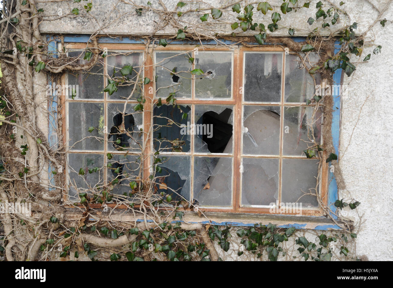 Abandoned cottage, broken windows, disrepair Stock Photo
