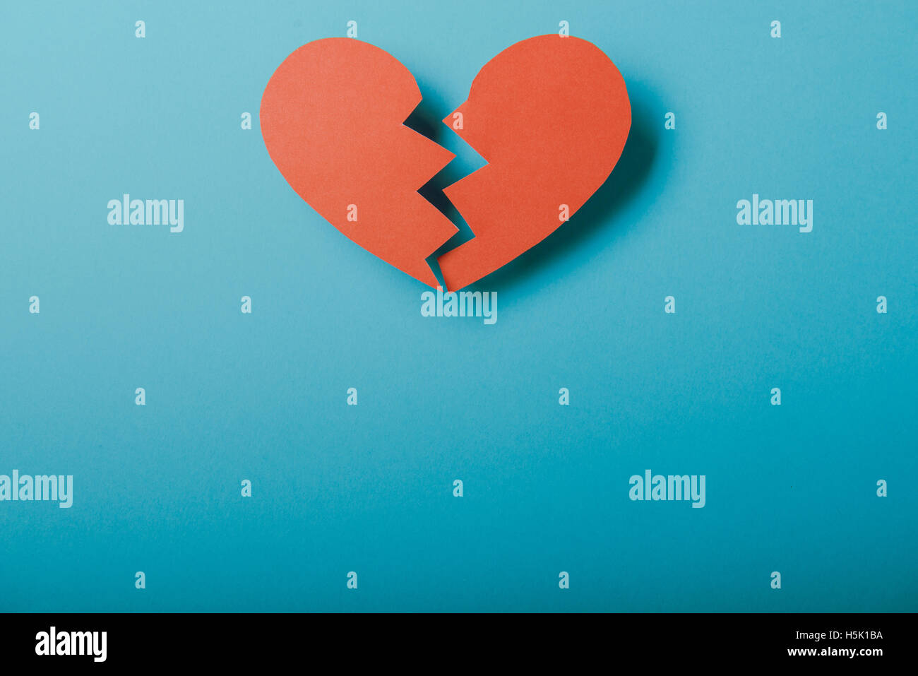 Red paper Valentines Day heart against a blue background Stock Photo ...