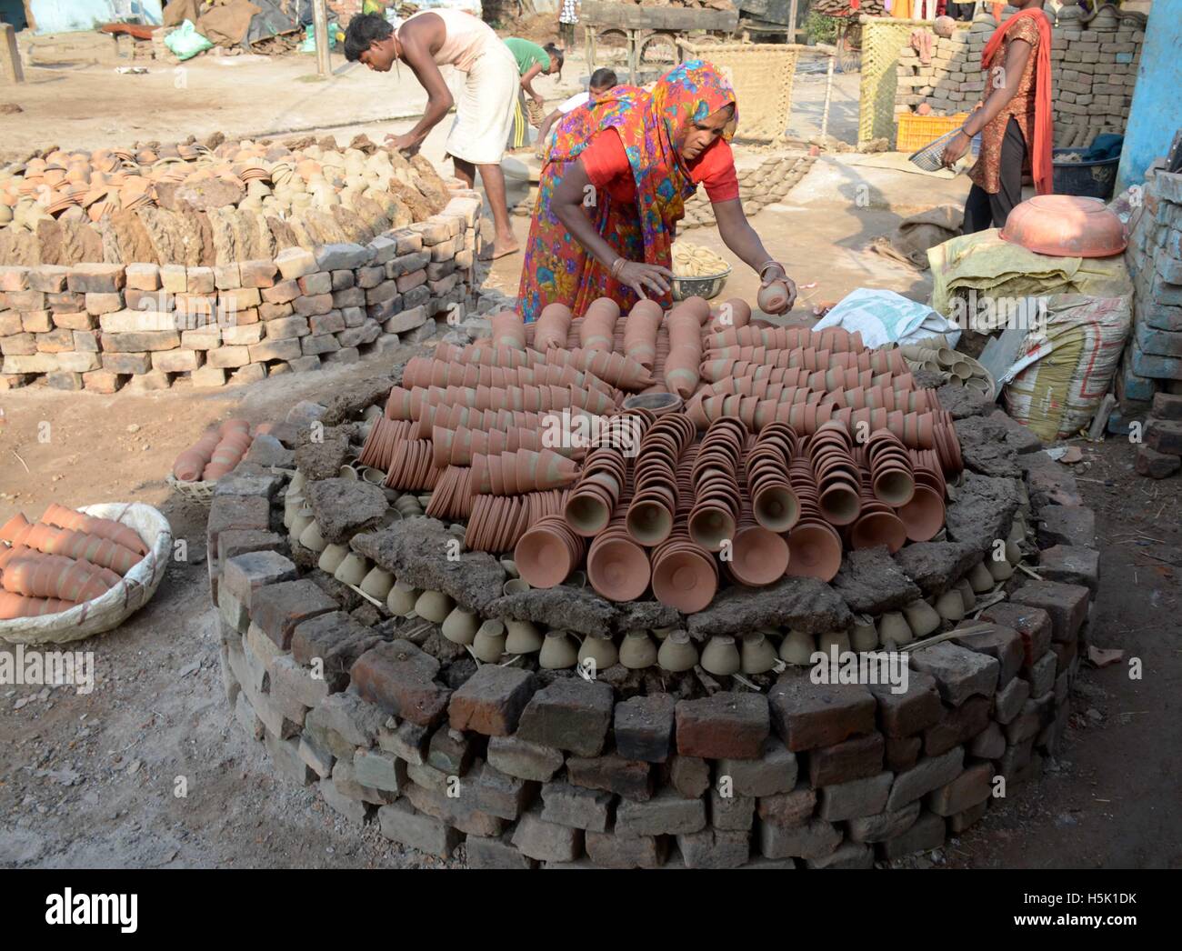 Allaahabd, India. 20th Oct, 2016. Potters prepare a hearth/bhatti to