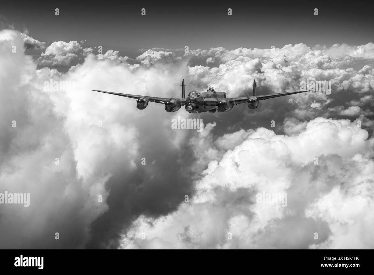 A depiction of a solitary RAF Avro Lancaster bomber making its way through sunlit clouds in July 1944. Black and white version. Stock Photo