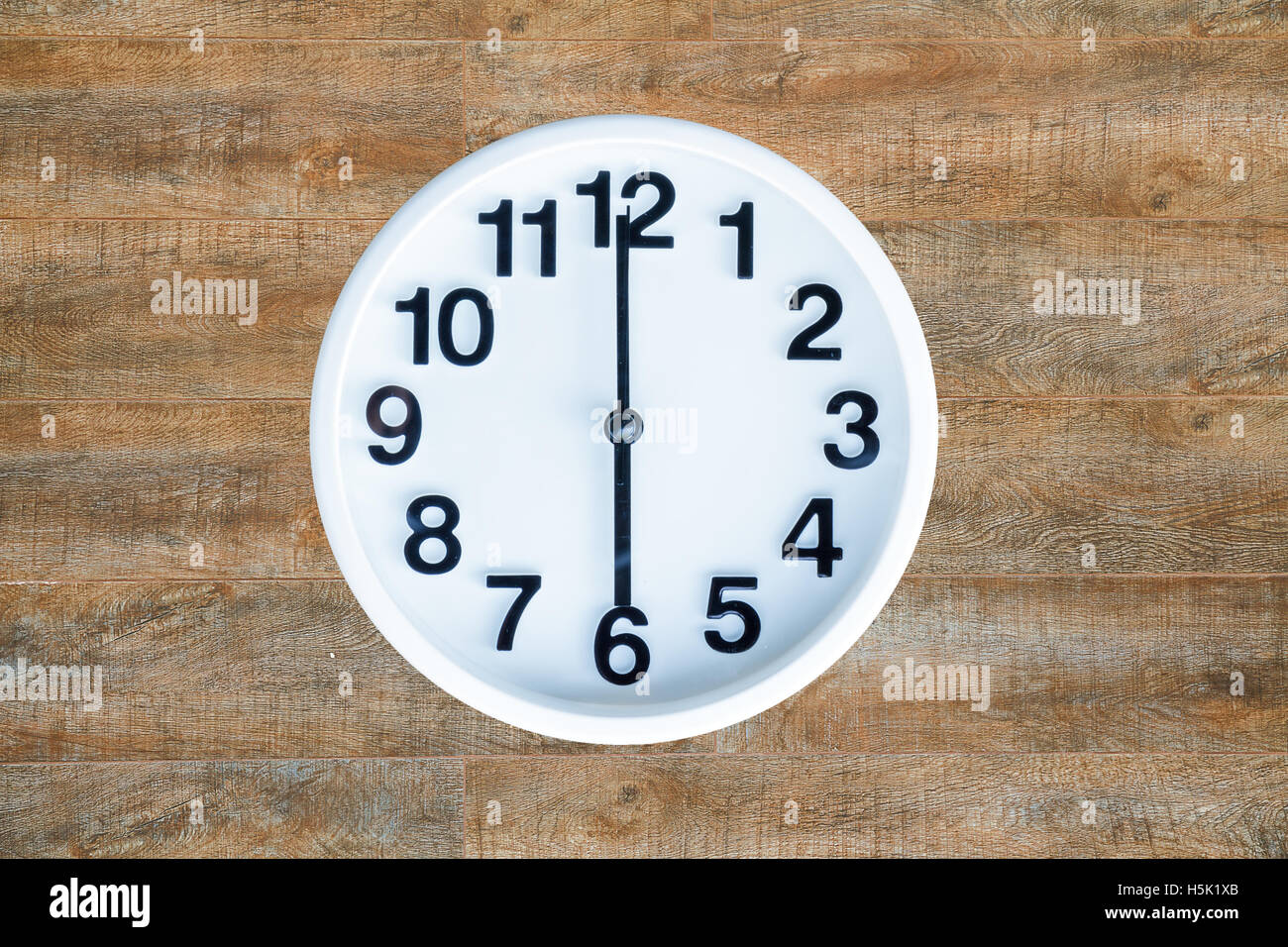 Clock show 6 am or pm on wood background with copy space. clipping path in picture. Stock Photo