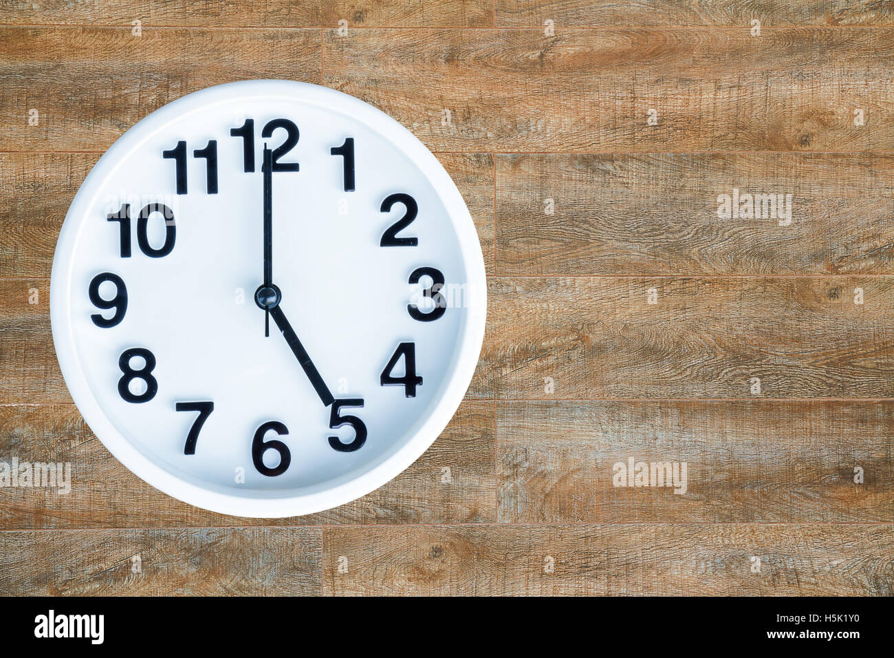 Clock show 5 am or pm on wood background with copy space. clipping path in  picture Stock Photo - Alamy