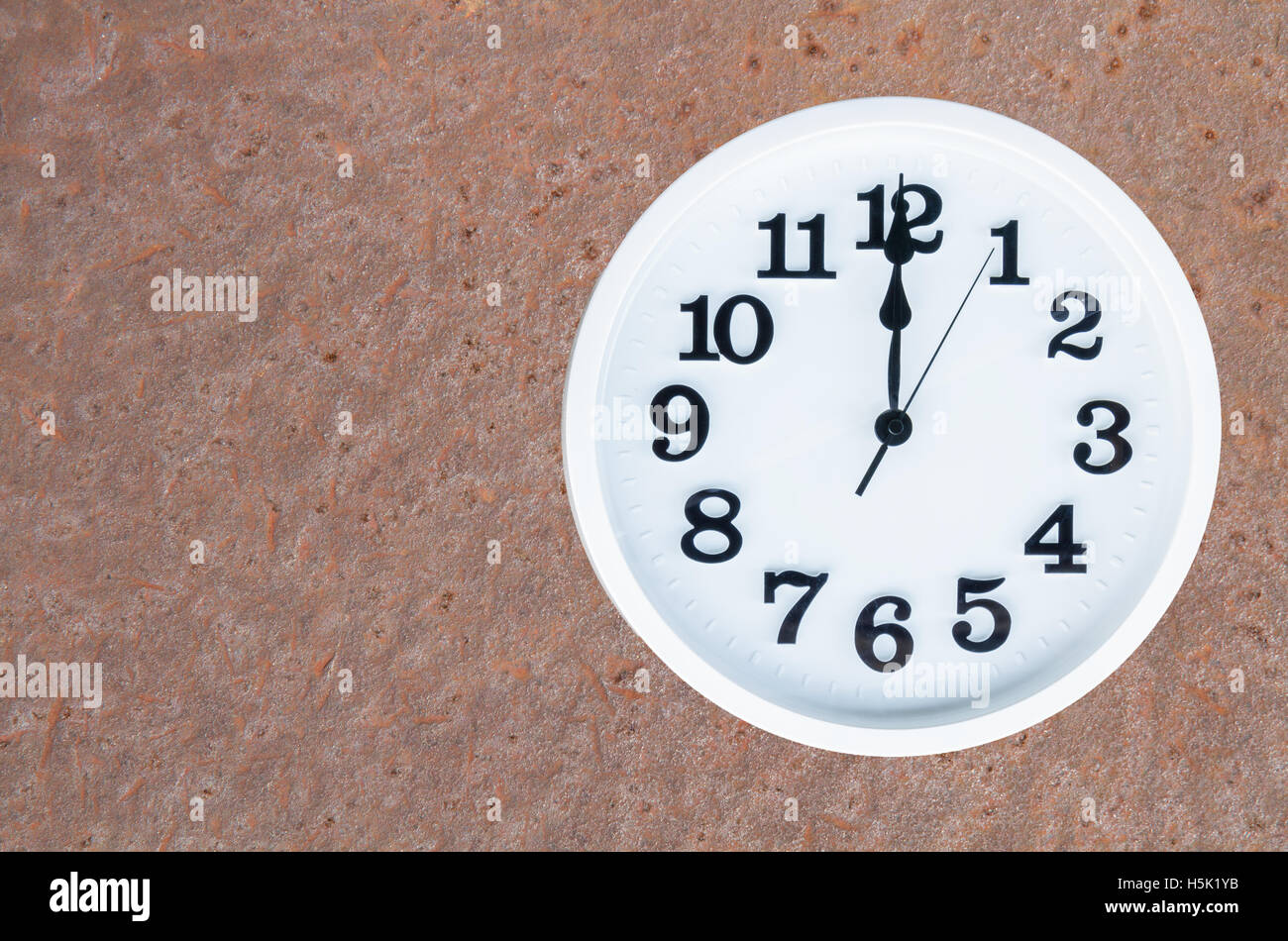 Clock show 12 am or pm on steel rusty background with copy space. clipping path in picture. Stock Photo