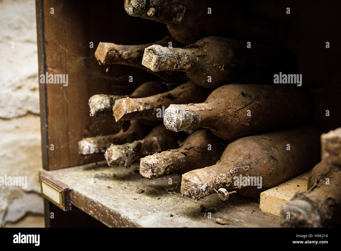 Lying dusty old bottles of wine in the Italian vineyard. Stock Photo