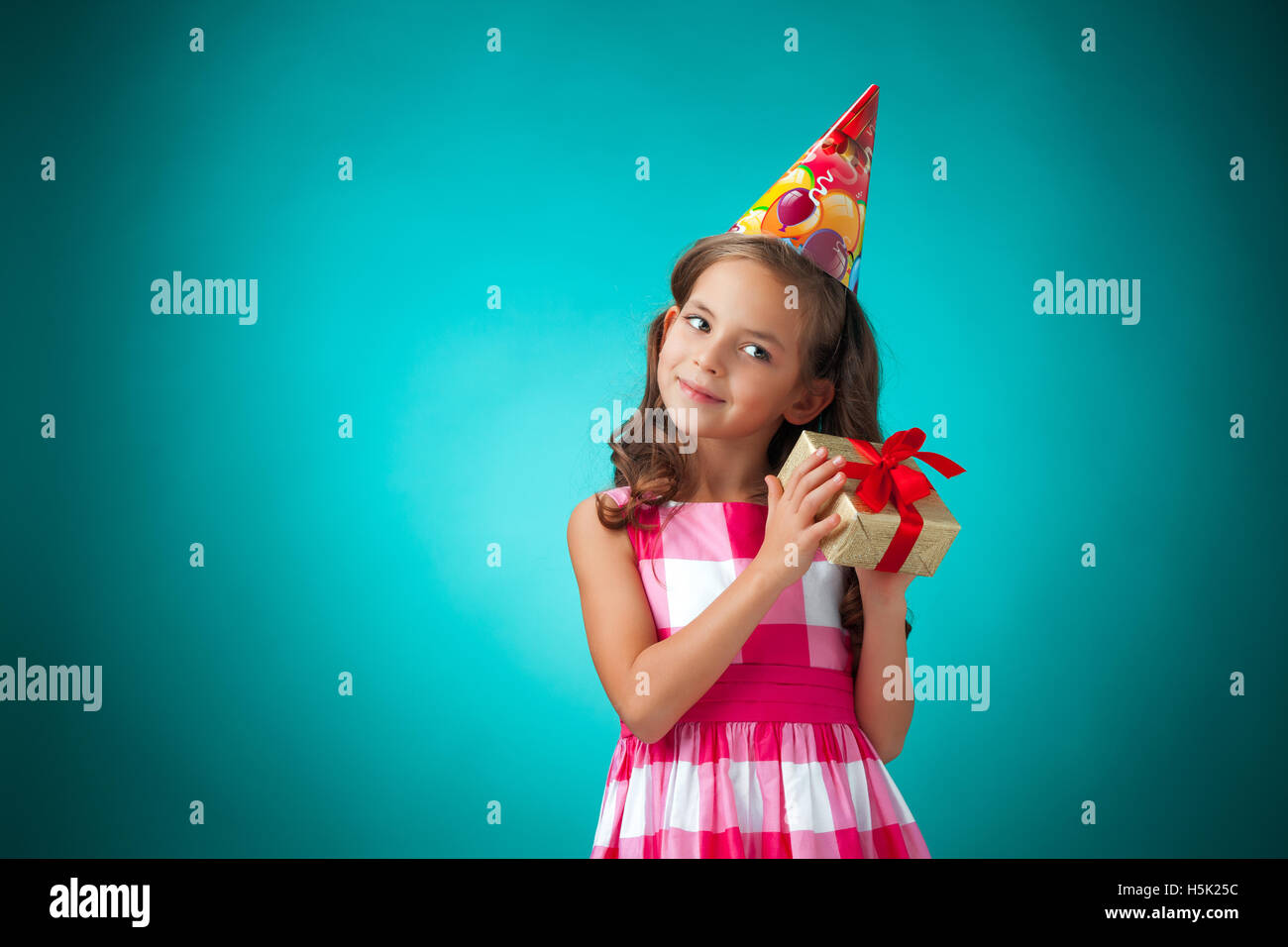 The cute cheerful little girl on blue background Stock Photo - Alamy