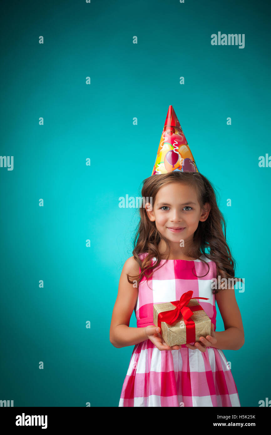The cute cheerful little girl on blue background Stock Photo - Alamy