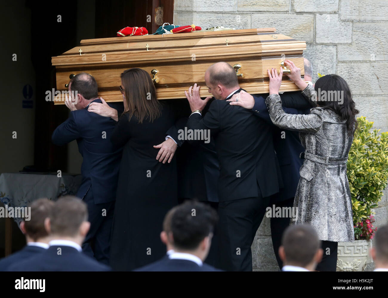 Anthony Foley's wife Olive (second left) helps carry his coffin into St