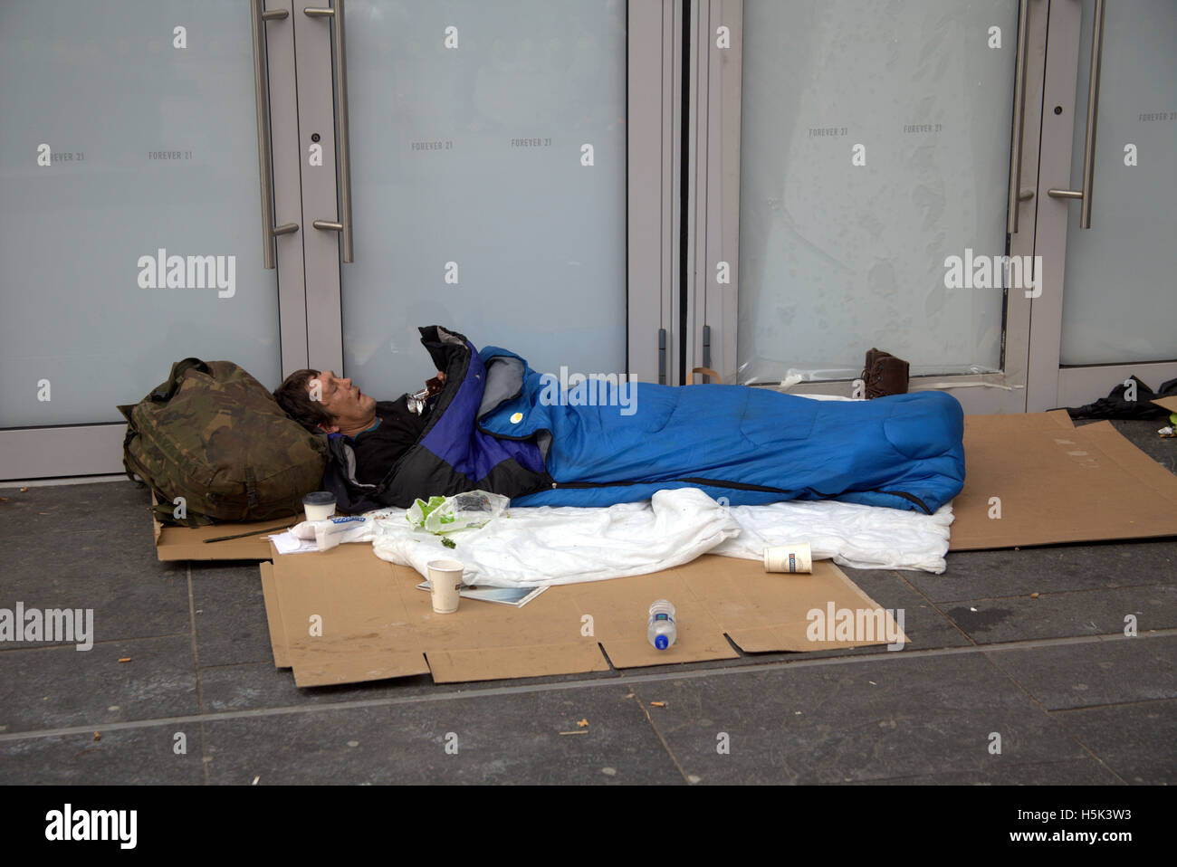 Homeless man with possessions in  Buchanan street, Glasgow Stock Photo