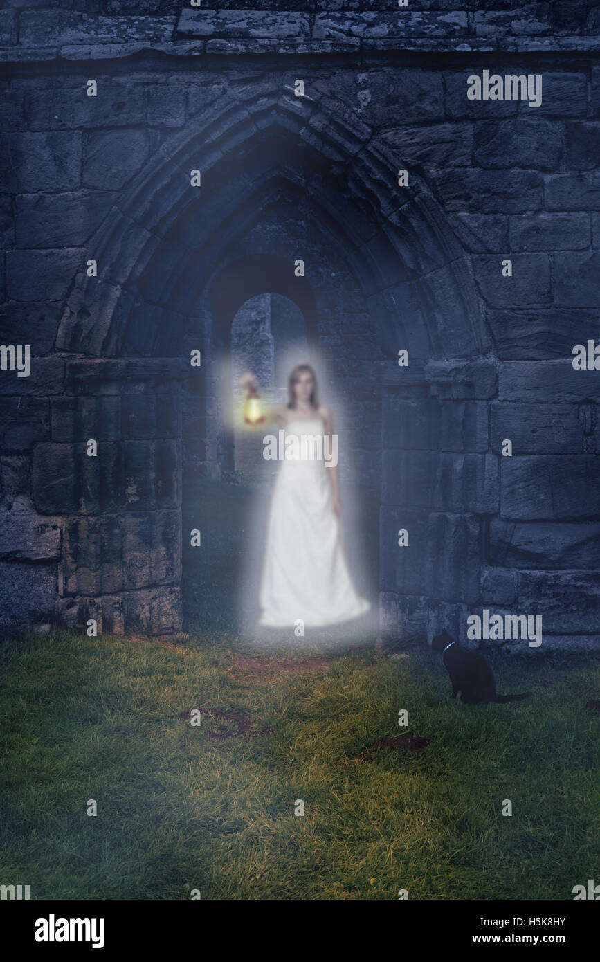 Ghost holding lantern in the archway of an ancient abbey Stock Photo