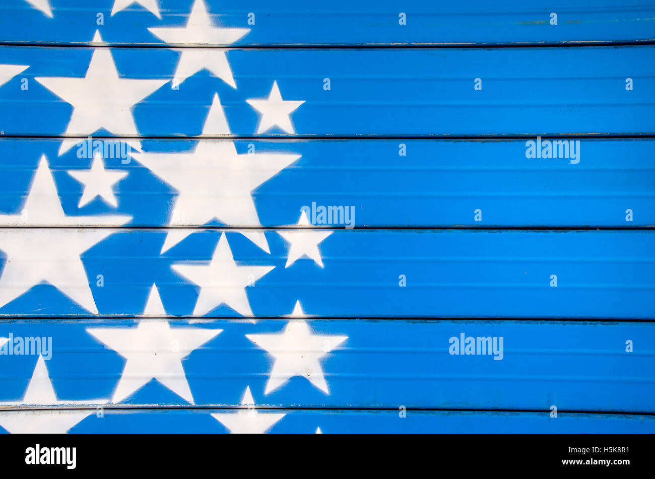 white stars on blue background painted on a closed shutter Stock Photo