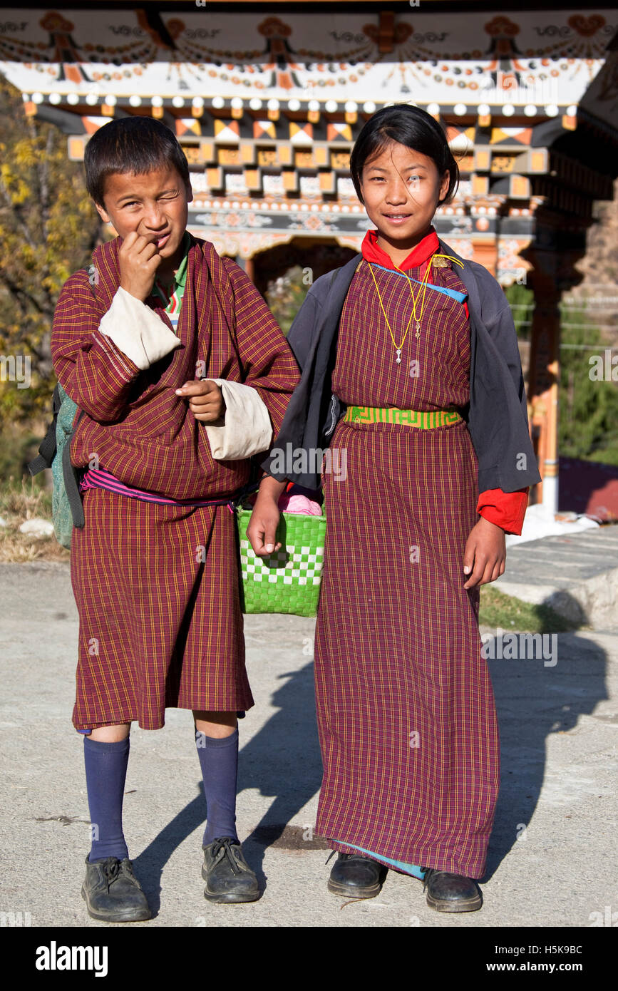 Children wearing gho and kira, national Bhutan dress for men and women, Bhutan, South Asia Stock Photo